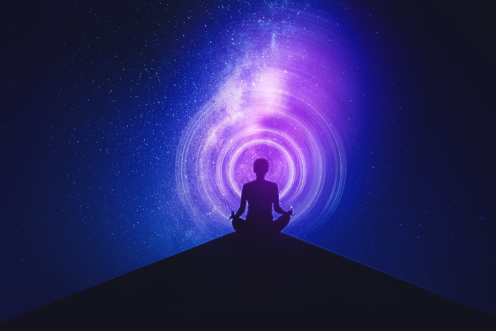 Silhouette of young woman doing yoga exercise on the mountain while meditating with milky way background. Shot in the metaverse